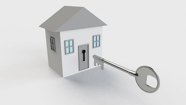 klíč a model domu v šedé